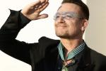 Musician Bono, lead singer of the band U2, reacts after being awarded as Commandeur des Arts et lettres (Commander in the Order of Arts and Letters) by French Culture Minister Aurelie Filippetti during a ceremony at the ministry in Paris July 16, 2013. 