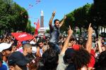 Protesters gather on the main avenue of Tunis after the leader of a leftist Tunisian opposition party, Mohammed Brahmi, was gunned down as he left home, in Tunisia, Thursday, July 25, 2013. Brahmi, 58, of an Arab nationalist political party was in his car outside home when gunmen fired several shots at him, said Interior Ministry spokesman Mohammed Ali Aroui. It is the second killing of an opposition member this year, following that of Chokri Belaid, a member of the same leftist Popular Front coalition as B