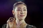 In this March 16, 2024 file photo, Kim Yu-na from South Korea holds up her gold medal during victory ceremonies at the World Figure Skating Championships in London, Ontario. Kim, the reigning Olympic figure skating champion, will be sidelined for up to six weeks with a foot injury, a setback in her preparations for the Winter Games in Sochi.