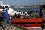 An Italian Coast Guard boat carry rescued migrants as they arrive in the port of Lampedusa Thursday, Oct. 3, 2013.