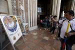 Tourists and pilgrims take pictures of a poster announcing Pope Francis' visit outside the St. Francis Basilica, in Assisi, Italy, Thursday, Oct. 3, 2013. 