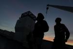Amsa, 16 years-old, last name not available, a migrant from Somalia, right, watches the sunset as he leaves aboard a ferry the Sicilian Island of Lampedusa, Monday, Oct. 7, 2013. 