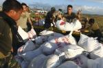 Philippine military personnel unload relief goods to be distributed to those affected by Typhoon Haiyan at the airport in Tacloban, Philippines, Monday, Nov. 18, 2013.