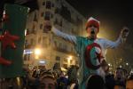 Algerian people celebrate their victory after the World Cup qualifying playoff second leg soccer match against Burkina Faso, in Algiers, Tuesday, Nov. 19, 2013. Algeria won 1-0 to qualify for the 2014 World Cup in Brazil. 