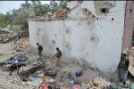 Afghan security personnel inspect a damaged police post following an airstrike in Bati Kot district in Nangarhar province on August 1, 2013. 