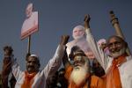 VADODRA, INDIA - APRIL 09: Muslim supporters of Bharatiya Janata Party (BJP) leader Narendra Modi and a Hindu holy man hold placards at an event before Modi filed his nomination papers on April 9, 2024 in Vadodra, India. India is in the midst of a nine-phase election from April 7-May 12. Credit Kevin Frayer/Getty Images