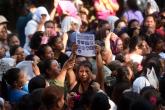 Relatives of inmates await news outside the Quezaltepeque prison, where at least 14 inmates were killed on the eve when violence erupted between two factions of a notorious gang, in Quezaltepeque, about 30 km north of the capital San Salvador, on August 23, 2015.