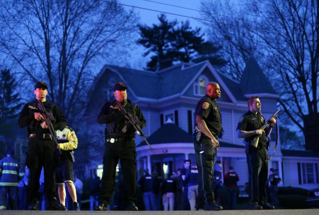 Police officers guard the entrance to Franklin street where there is an active crime scene search for the suspect in the Boston Marathon bombings, Friday, April 19, 2013, in Watertown, Mass. Police officers guard the entrance to Franklin street where there is an active crime scene search for the suspect in the Boston Marathon bombings, Friday, April 19, 2013, in Watertown, Mass.