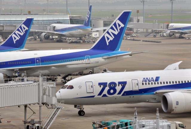 All Nippon Airways (ANA) jetliners sit parked at Tokyo's Haneda Airport on July 30, 2013.