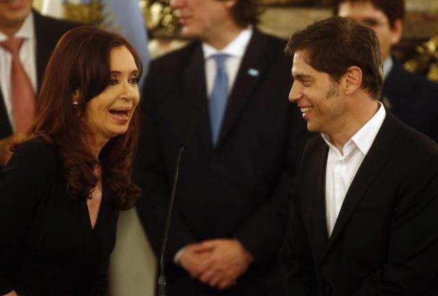 Argentina's President Cristina Fernandez de Kirchner talks to newly appointed Economy Minister Axel Kicillof (R) at the swearing-in ceremony at the Casa Rosada Presidential Palace in Buenos Aires November 20, 2013. Argentina's President Cristina Fernandez de Kirchner talks to newly appointed Economy Minister Axel Kicillof (R) at the swearing-in ceremony at the Casa Rosada Presidential Palace in Buenos Aires November 20, 2013.