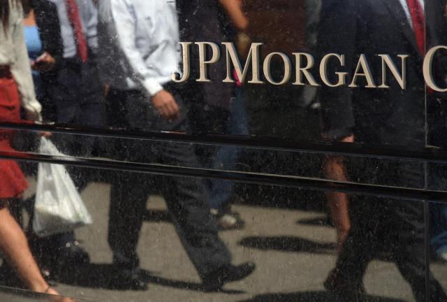 People walk by JP Morgan Chase & Company headquarters in New York, August 14, 2013. 