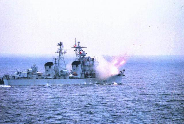 This undated file photo released 20 March by the official Chinese news agency, Xinhua, shows a Chinese destroyer firing missiles at a submarine from the 'enemy' side during a large-scale, live ammunition exercise in the South China Sea in mid-March by the air force and navy of the Chinese People's Liberation Army. 
