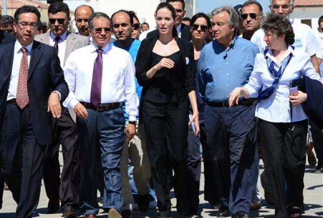 Hollywood star Angelina Jolie, center left, in her role as special envoy for the U. N. refugee agency, and UNHCR chief Antonio Guterres, center right, at the Oncupinar Syrian refugee camp in Kilis, Turkey, Thursday, Sept. 13, 2012. Jolie met with Syrian refugees in Turkey, after visiting Syrian refugee camps in Jordan and Lebanon. There are more than 80,000 Syrian refugees in 11 camps in Turkey. Hollywood star Angelina Jolie, center left, in her role as special envoy for the U. N. refugee agency, and UNHCR chief Antonio Guterres, center right, at the Oncupinar Syrian refugee camp in Kilis, Turkey, Thursday, Sept. 13, 2012. Jolie met with Syrian refugees in Turkey, after visiting Syrian refugee camps in Jordan and Lebanon. There are more than 80,000 Syrian refugees in 11 camps in Turkey.