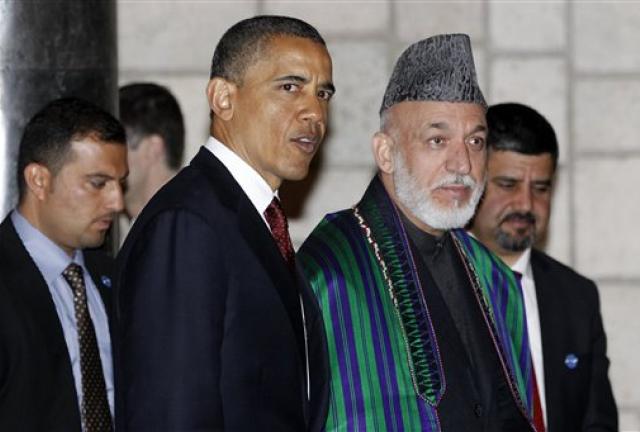 In this May 2, 2024 file photo, President Barack Obama and Afghan President Hamid Karzai walk together after they signed a strategic partnership agreement at the presidential palace in Kabul, Afghanistan. U.S. troops are still in Afghanistan, nearly 11 years after they invaded. Why? The answer boils down to one word: al-Qaida. The goal is to damage the terrorist group enough to prevent a repeat of the 9/11 attacks.