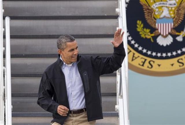President Barack Obama waves from Air Force One as he arrives in Madison, Wis., Thursday, Oct. 4, 2012. 