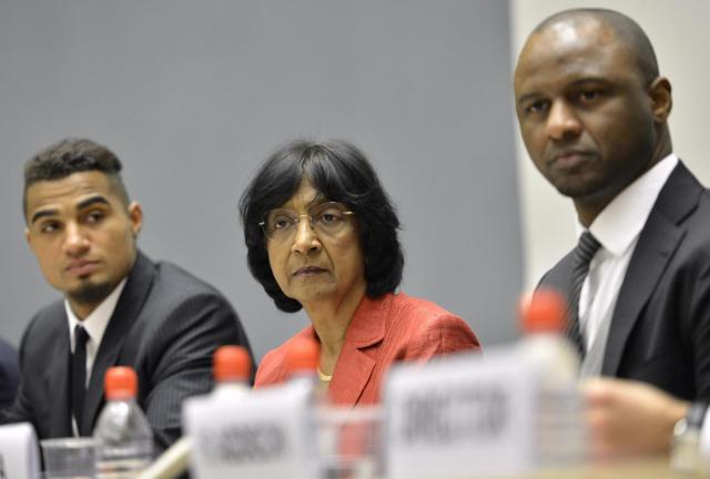 Ghana's Kevin-Prince Boateng and AC Milan soccer player, left, U.N. High Commissioner for Human Rights South African Navanethem Pillay, center, and Patrick Vieira, right, former captain of the French national football team and current Football Development Executive at Manchester City Football Club, pose for a photographers prior to a panel discussion on Racism and Sport during the World Humanitarian Day at the European headquarters of the United Nations in Geneva, Switzerland, Thursday, March 21, 2013. The 