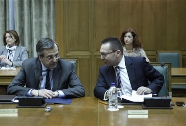 Greek Prime Minister Antonis Samaras, left, talks with Finance Minister Yannis Stournaras during a cabinet meeting in Athens, on Thursday, April 25, 2013. Greek Prime Minister Antonis Samaras, left, talks with Finance Minister Yannis Stournaras during a cabinet meeting in Athens, on Thursday, April 25, 2013.