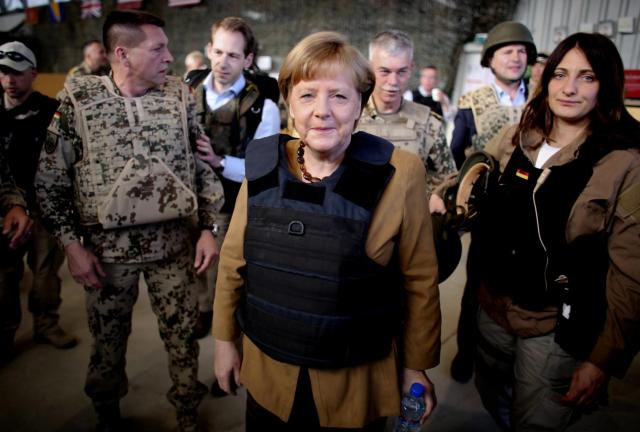 German Chancellor Angela Merkel, center, is dressed in a bullet proofed vest as she arrives to Mazar-e-Sharif, Afghanistan, Friday, May 10, 2013.