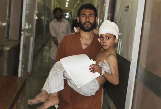 A young injured Afghan boy is carried by his father into the emergency room at the hospital in Kandahar, Afghanistan, Friday, May 17, 2013 after a car bomb exploded inside an elite gated community linked to the family of Afghan President Hamid Karzai. A young injured Afghan boy is carried by his father into the emergency room at the hospital in Kandahar, Afghanistan, Friday, May 17, 2013 after a car bomb exploded inside an elite gated community linked to the family of Afghan President Hamid Karzai.