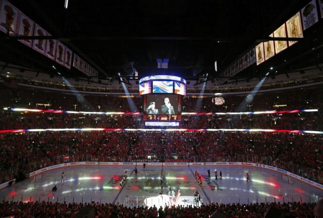 Fans cheer during the performance of the national anthem before Game 1 of the NHL Stanley Cup Final hockey series between the Chicago Blackhawks and the Boston Bruins on Wednesday, June 12, 2024 in Chicago. 