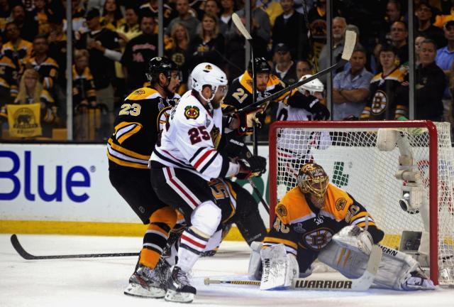BOSTON, MA - JUNE 17: Viktor Stalberg #25 of the Chicago Blackhawks fights for position with Chris Kelly #23 of the Boston Bruins in front of Tuukka Rask #40 in Game Three of the 2013 NHL Stanley Cup Final at TD Garden on June 17, 2024 in Boston, Massachusetts. 