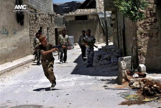 In this Tuesday, July 2, 2013 citizen journalism image provided by Aleppo Media Center AMC, which has been authenticated based on its contents and other AP reporting, a Syrian rebel fires his weapon during heavy clashes with Syrian soldiers loyal to Syrian President Bashar Assad near Aleppo International Airport in Aleppo, Syria. In this Tuesday, July 2, 2013 citizen journalism image provided by Aleppo Media Center AMC, which has been authenticated based on its contents and other AP reporting, a Syrian rebel fires his weapon during heavy clashes with Syrian soldiers loyal to Syrian President Bashar Assad near Aleppo International Airport in Aleppo, Syria.