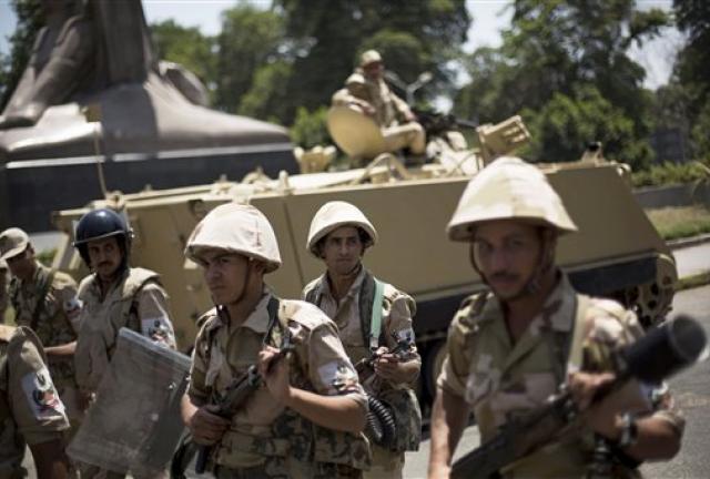 Egyptian soldiers deploy near Cairo University, where Muslim Brotherhood supporters have gathered to support ousted president Mohammed Morsi in Cairo, Thursday, July 4, 2013. The chief justice of Egypt's Supreme Constitutional Court was sworn in Thursday as the nation's interim president, taking over hours after the military ousted the Islamist President Mohammed Morsi. Adly Mansour took the oath of office at the Nile-side Constitutional Court in a ceremony broadcast live on state television.