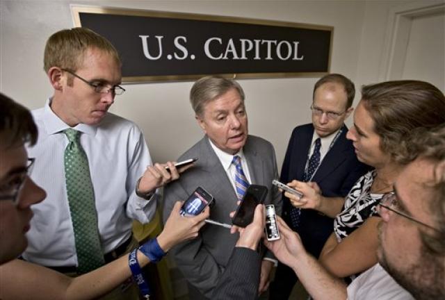 Sen. Lindsey Graham, R-S.C., center, is surrounded by reporters on Capitol Hill in Washington, Tuesday, July 30, 2013, during a roll call. 