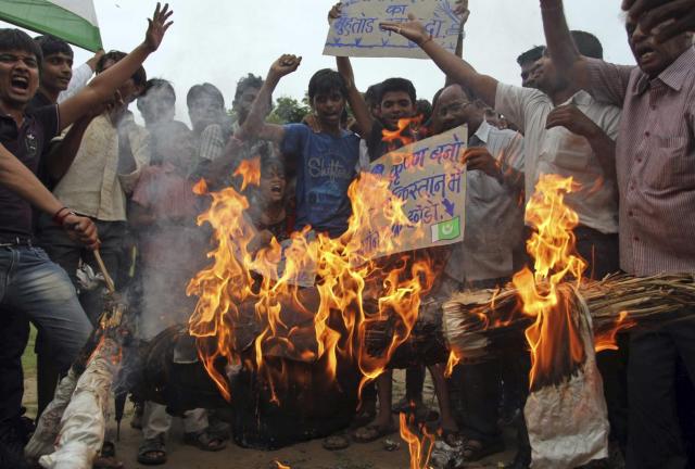 Indian protesters burn an effigy of Pakistani Prime Minister Nawaz Sharif during a protest in Ahmadabad, India, Saturday, Aug. 10, 2013.