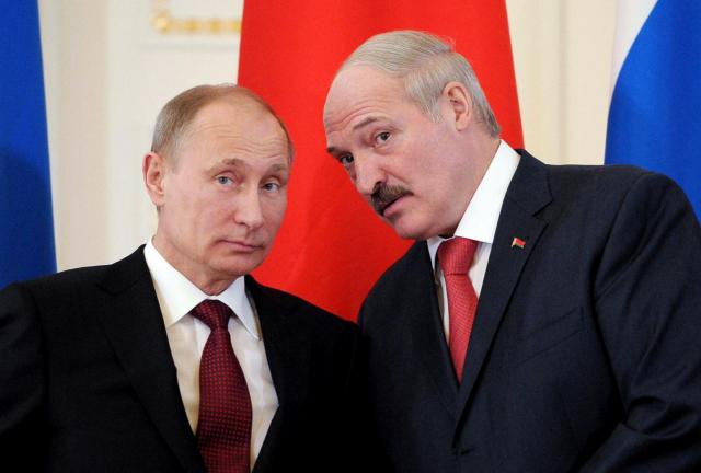 Russia's President Vladimir Putin (L) and his Belarus counterpart Alexander Lukashenko seen at the Konstantinovsky palace just outside St.Petersburg, on March 15, 2013.