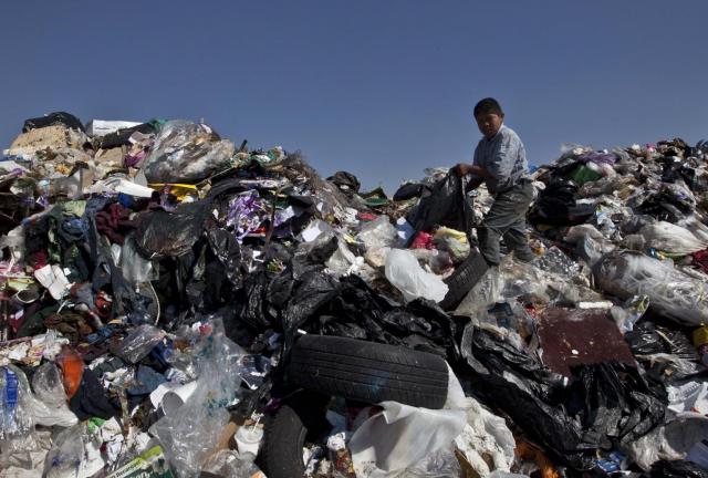 In this Dec. 19, 2011 file photo, a boy selects garbage to recycle at the landfill Bordo Poniente on the outskirts of Mexico City.
