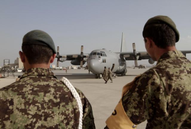 Afghan National Army forces look towards a C-130 transport aircraft at the Afghan Air Force Base in Kabul, Afghanistan, Wednesday, Oct. 9, 2013. Afghan National Army forces look towards a C-130 transport aircraft at the Afghan Air Force Base in Kabul, Afghanistan, Wednesday, Oct. 9, 2013.