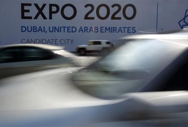 In this Wednesday Nov. 20, 2013, vehicles pass by a billboard advertising Dubai as a candidate city for the Expo 2020 in Dubai, United Arab Emirates. In this Wednesday Nov. 20, 2013, vehicles pass by a billboard advertising Dubai as a candidate city for the Expo 2020 in Dubai, United Arab Emirates.