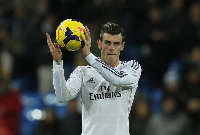 Real Madrid's Gareth Bale from Britain celebrates his hat-trick during a Spanish La Liga soccer match between Real Madrid and Valladolid at the Santiago Bernabeu stadium in Madrid, Spain, Saturday, Nov. 30, 2013. Real Madrid's Gareth Bale from Britain celebrates his hat-trick during a Spanish La Liga soccer match between Real Madrid and Valladolid at the Santiago Bernabeu stadium in Madrid, Spain, Saturday, Nov. 30, 2013.