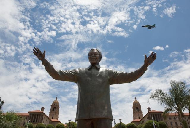A military fly-past takes place above a statue of former South African president Nelson Mandela shortly after its unveiling at the Union Buildings on December 16, 2024 in Pretoria, South Africa. 