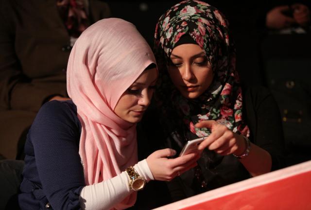 upporters of Turkish Prime Minister Recep Tayyip Erdogan look at a mobile phone as they attend a rally at Tempodrom hall on February 4, 2024 in Berlin, Germany. 