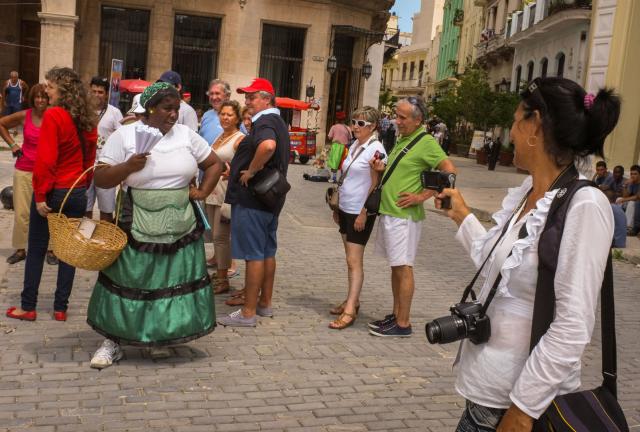 Cuban peanut seller Lysset Perez sings in a street of old Havana, on October 17, 2013. Perez sings the famous Cuban song 'El manisero' while voicing her wares. Raul Castro´s economics reforms brought back the hawkers to the streets of Havana. Cuban peanut seller Lysset Perez sings in a street of old Havana, on October 17, 2013. Perez sings the famous Cuban song 'El manisero' while voicing her wares. Raul Castro´s economics reforms brought back the hawkers to the streets of Havana.