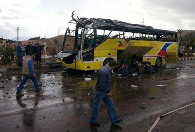 Police look at the wreckage of a tourist bus at the site of a bomb explosion in Egypt on February 16, 2014. Police look at the wreckage of a tourist bus at the site of a bomb explosion in Egypt on February 16, 2014.