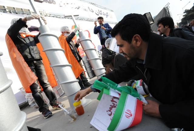 ranian children build model centrifuges out of styrofoam and glue in a competition beneath a banner reading 'Nuclear scientists of the next generation,' as Iranians stage a mass rally to mark the 35th anniversary of the 1979 Islamic revolution on February 11, 2014 in Tehran, Iran. ranian children build model centrifuges out of styrofoam and glue in a competition beneath a banner reading 'Nuclear scientists of the next generation,' as Iranians stage a mass rally to mark the 35th anniversary of the 1979 Islamic revolution on February 11, 2014 in Tehran, Iran.