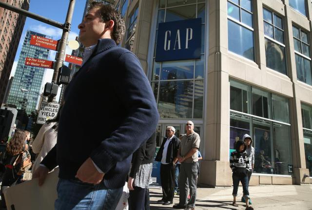 Shoppers walk past a GAP store along the Magnificent Mile shopping district on September 13, 2013 in Chicago, Illinois. Shoppers walk past a GAP store along the Magnificent Mile shopping district on September 13, 2013 in Chicago, Illinois.