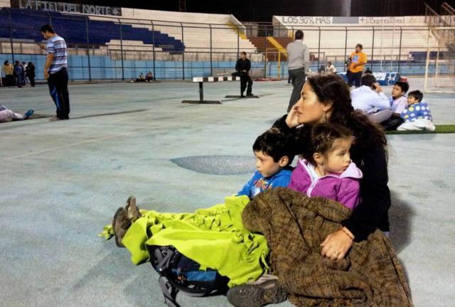 Locals take refuge at the city stadium following a tsunami alert after a powerful 8.0-magnitude earthquake hit off Chile’s Pacific coast, on April 1, 2014 in Iquique. Locals take refuge at the city stadium following a tsunami alert after a powerful 8.0-magnitude earthquake hit off Chile’s Pacific coast, on April 1, 2014 in Iquique.