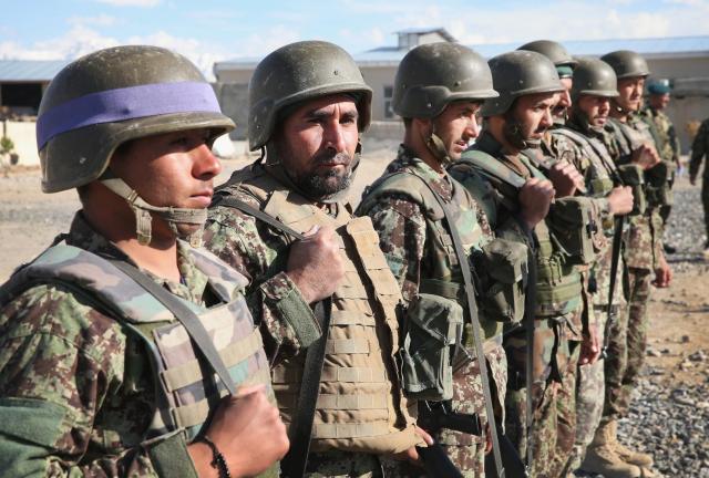 fghan National Army (ANA) soldiers participate in a flag-lowering ceremony at Camp Maiwand on April 2, 2024 near Pul-e Alam, Afghanistan. 