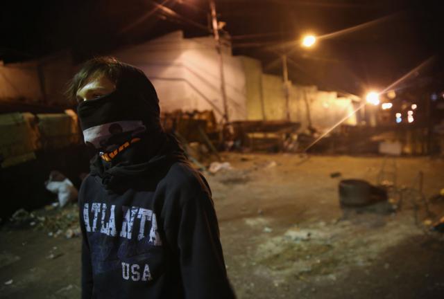 A young protester manns a barricade before dawn on March 9, 2014 in San Cristobal, the capital of Tachira state, Venezuela. A young protester manns a barricade before dawn on March 9, 2014 in San Cristobal, the capital of Tachira state, Venezuela.