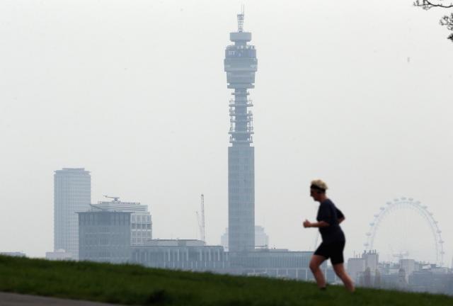 A woman runs to the top of Primrose Hill, with the London skyline in the background on April 3, 2014 in London, England. A woman runs to the top of Primrose Hill, with the London skyline in the background on April 3, 2014 in London, England.