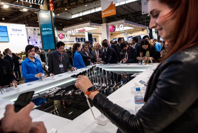 Visitors look at new Samsung devices during the second day of the Mobile World Congress 2014 at the Fira Gran Via complex on February 25, 2014 in Barcelona, Spain. Visitors look at new Samsung devices during the second day of the Mobile World Congress 2014 at the Fira Gran Via complex on February 25, 2014 in Barcelona, Spain.