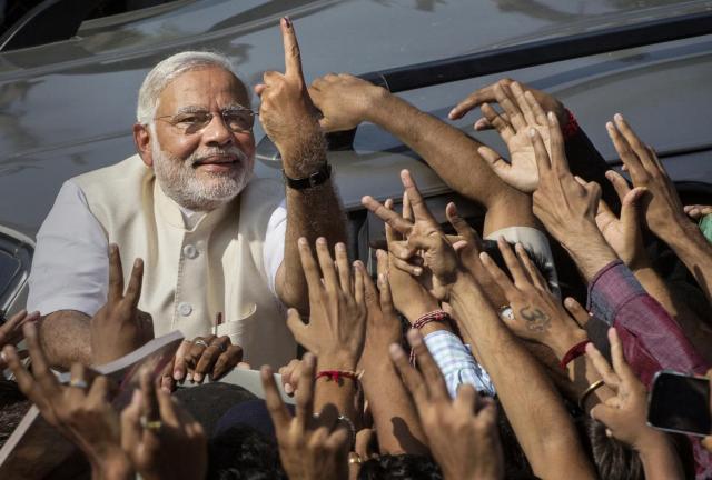 BJP leader Narendra Modi shows his inked finger to supporters as he leaves a polling station after voting on April 30, 2024 in Ahmedabad, India. India is in the midst of a nine phase election that began on April 7 and ends May 12.