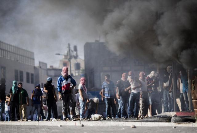 JERUSALEM, ISRAEL - JULY 02: Palestinian youths clash with Israeli Police near to the house of murdered Palestinian teenager Mohammed Abu Khdair, in Jerusalem on July 2, 2024 in Jerusalem, Israel. Israeli Police found a burnt body in a forest west of Jerusalem, early on Wednesday morning, in what appears to have been a revenge kidnapping and murder carried out by right-wing Israeli extremists after three Israeli teenage boys were found dead on Monday north of the Palestinian town Halhul, near Hebron. Credit