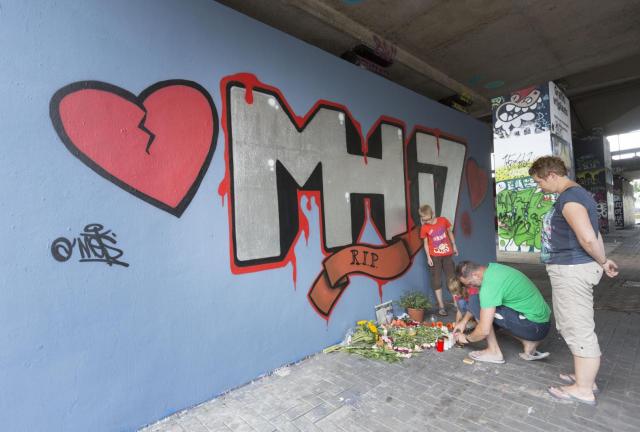 People look at graffiti on a wall that commemorates the victims of the Malaysia Airlines Flight MH17 crash underneath a flyover July 26, 2014 in Koog aan de Zaan, The Netherlands. The aircraft was allegedly shot down by a missile and investigations continue over the perpetrators of the attack. People look at graffiti on a wall that commemorates the victims of the Malaysia Airlines Flight MH17 crash underneath a flyover July 26, 2014 in Koog aan de Zaan, The Netherlands. The aircraft was allegedly shot down by a missile and investigations continue over the perpetrators of the attack.