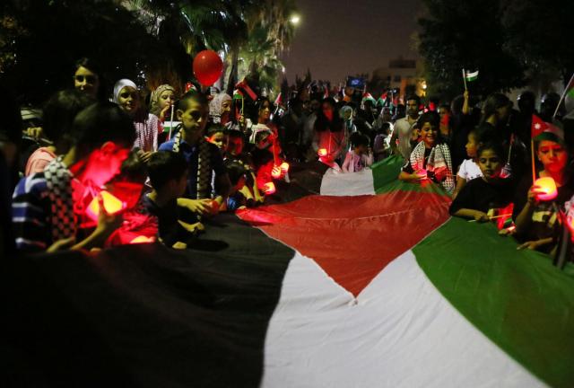 Children hold a candlelight vigil in solidarity with victims of bombings in Gaza on August 5, 2014 in Amman, Jordan. Children hold a candlelight vigil in solidarity with victims of bombings in Gaza on August 5, 2014 in Amman, Jordan.