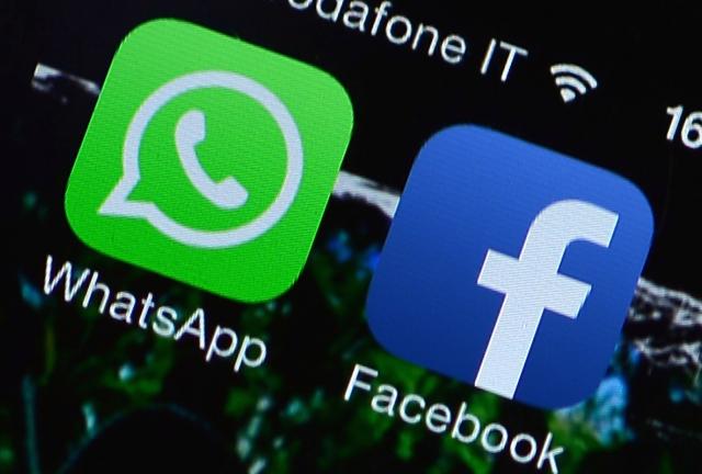 This file picture taken on February 20, 2024 in Rome shows the Facebook and WhatsApp applications' icons displayed on a smartphone. 